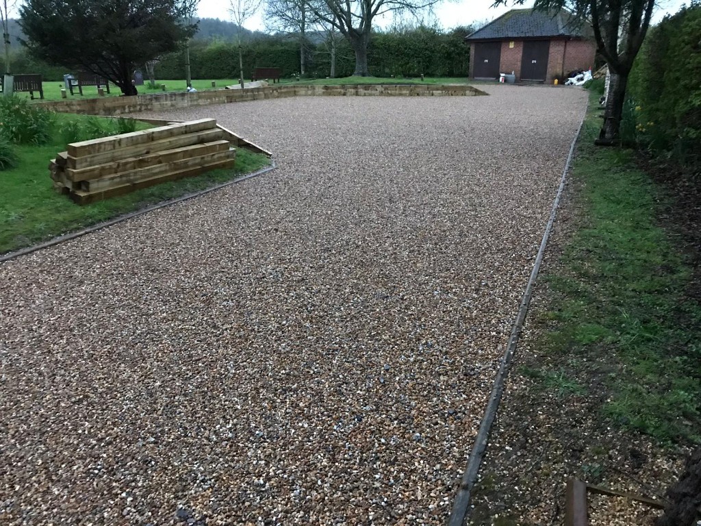 Gravel parking and circulation with sleeper retaining walls