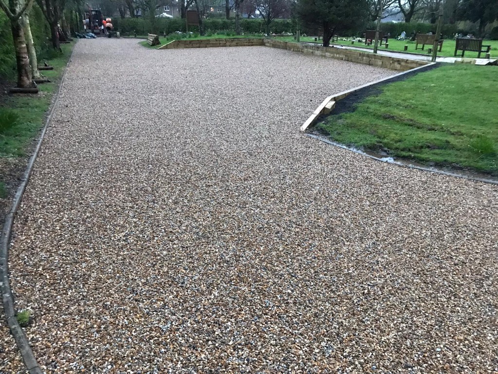 New gravel surfacing beside lawns, benches and memorial plots