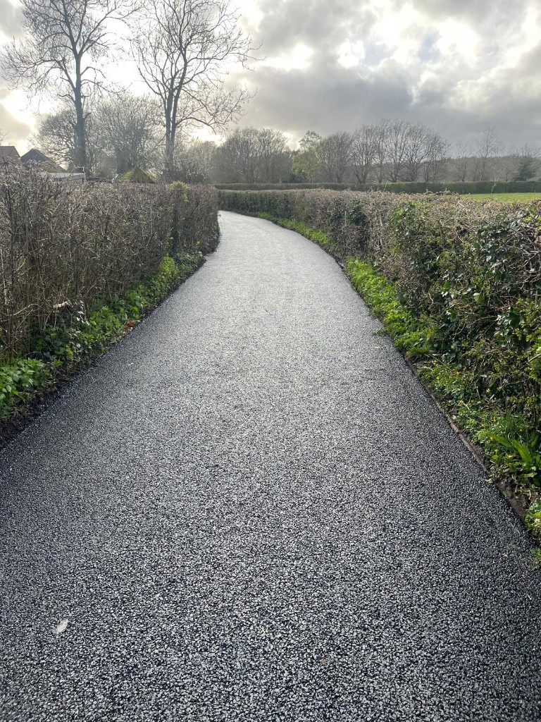 Resurfaced rural lane between hedges — access renewal