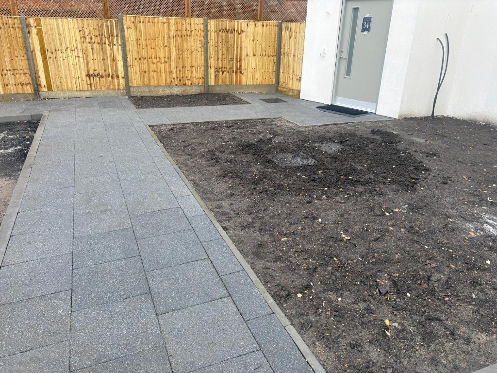 Development access — machine-laid asphalt between new-build blocks