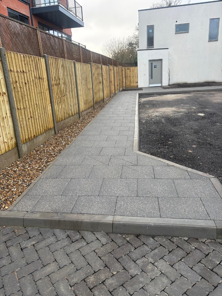 Pedestrian slab walkway — kerbs, gravel strip and block paving interface