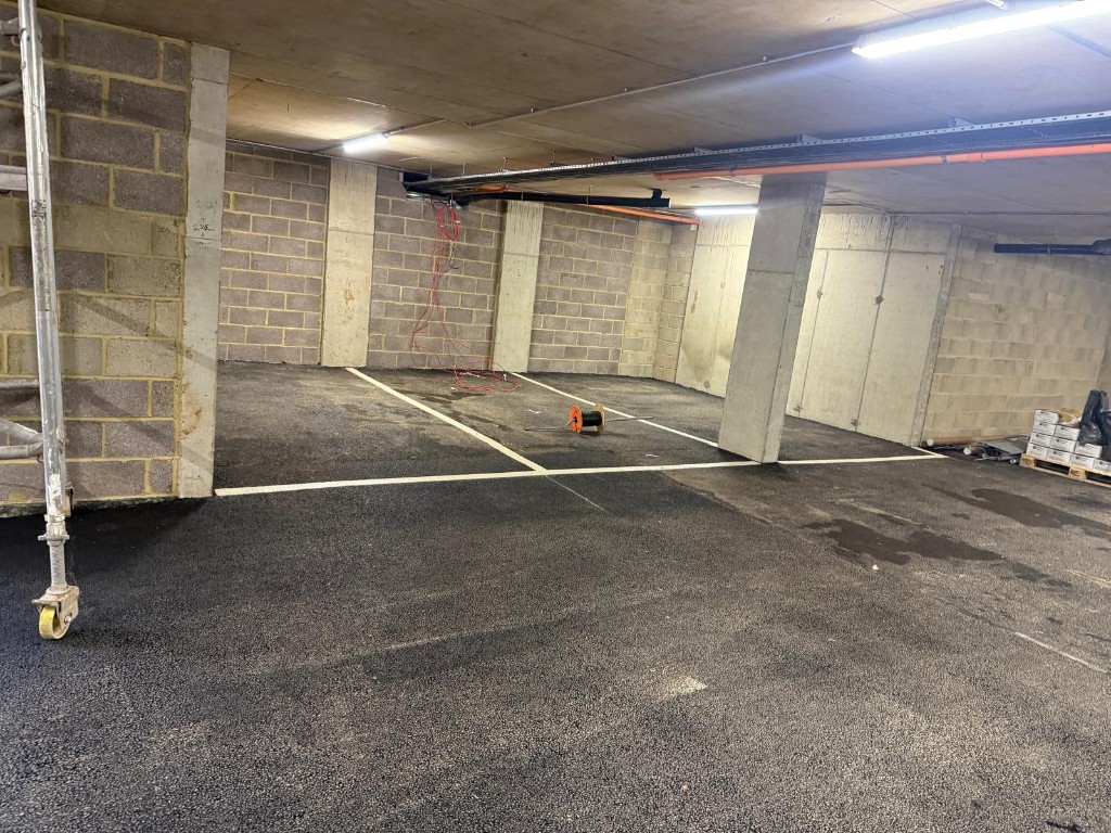 Basement parking deck — new asphalt wearing course and bay lining