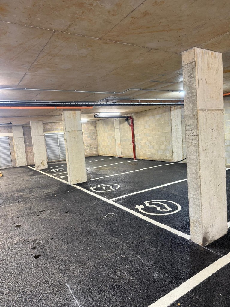EV charging bays — stencil symbols and white thermoplastic lines