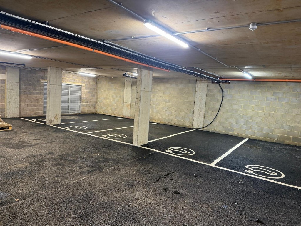Indoor parking row — lined stalls ready for charger installation