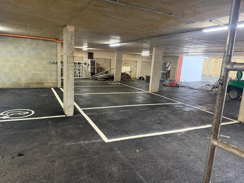 Ground-floor garage — black asphalt and crisp stall markings