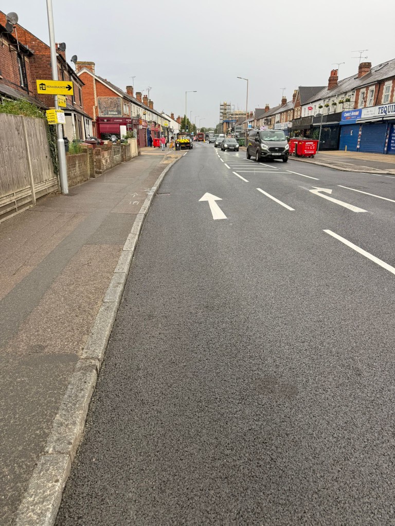 Public road resurfacing with directional arrows and refreshed lining