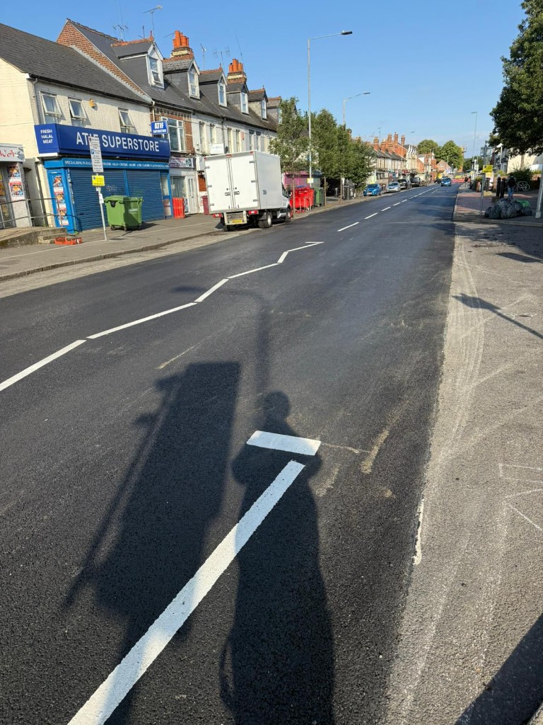 Local parade road — black asphalt wearing course and white markings