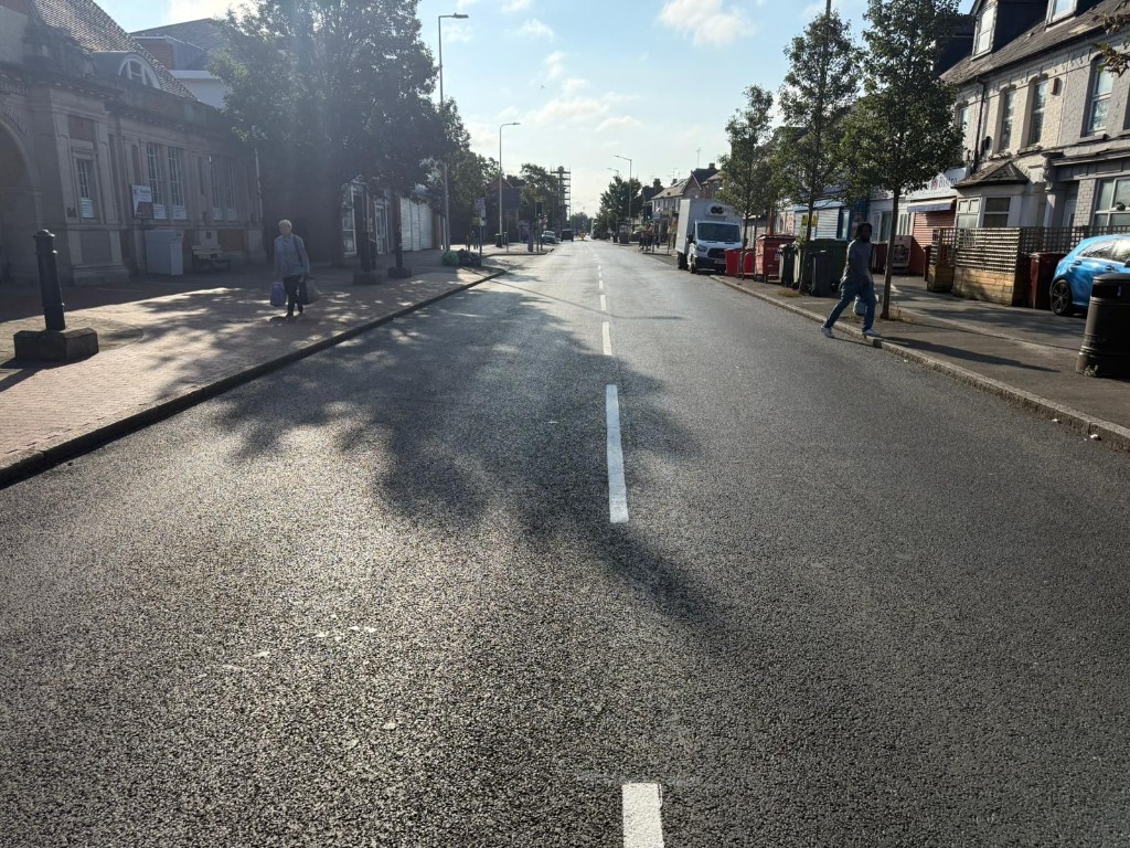 Town-centre carriageway — renewed surface, channels and street lighting