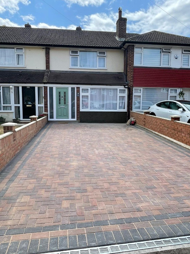 Residential paving and brick edging alongside landscaped beds