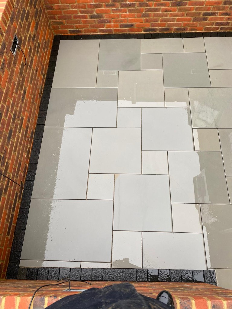 Residential entrance with multi-tone natural stone slabs and neat soldier border