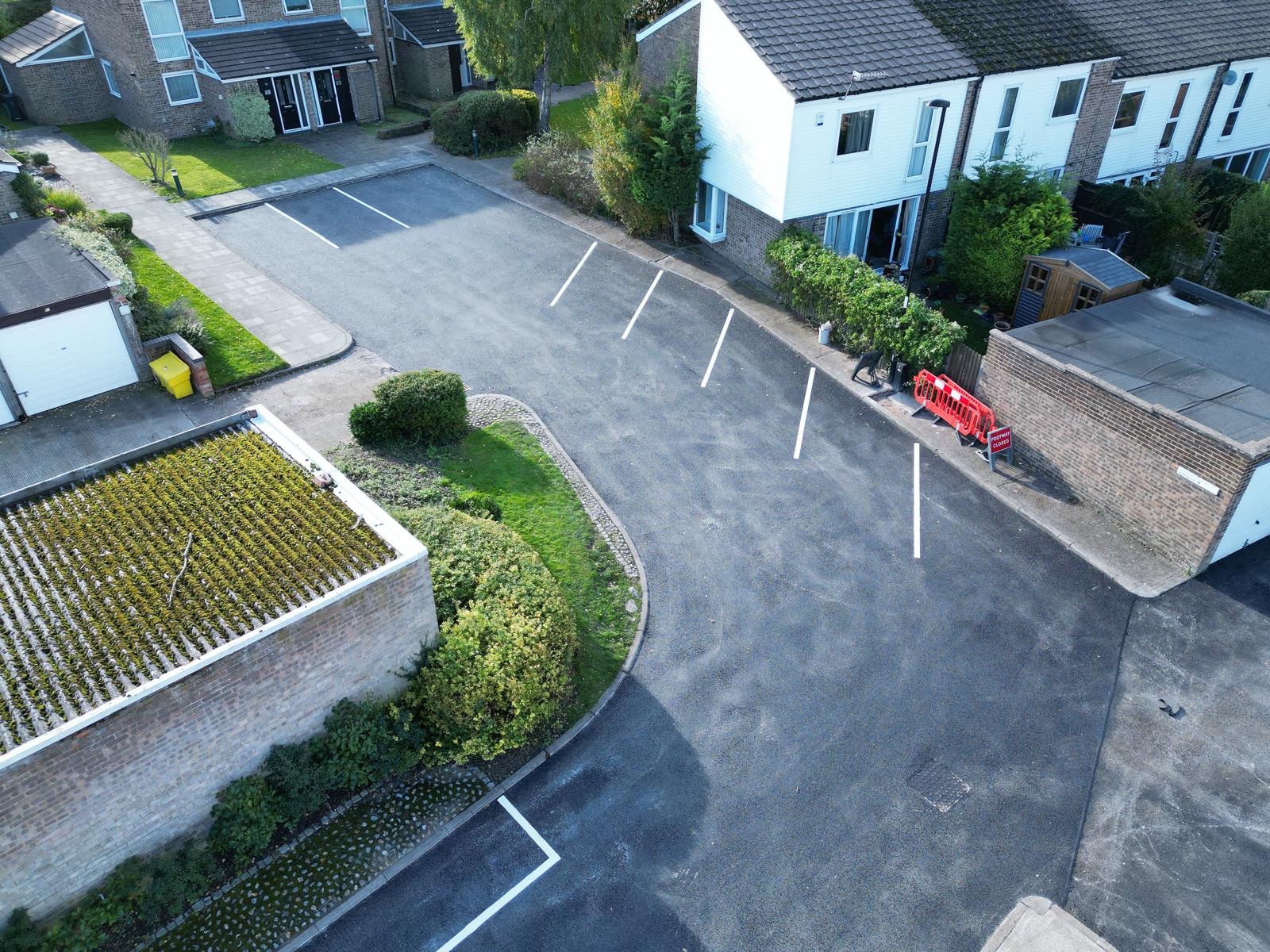 Commercial resurfacing with compacted asphalt finish
