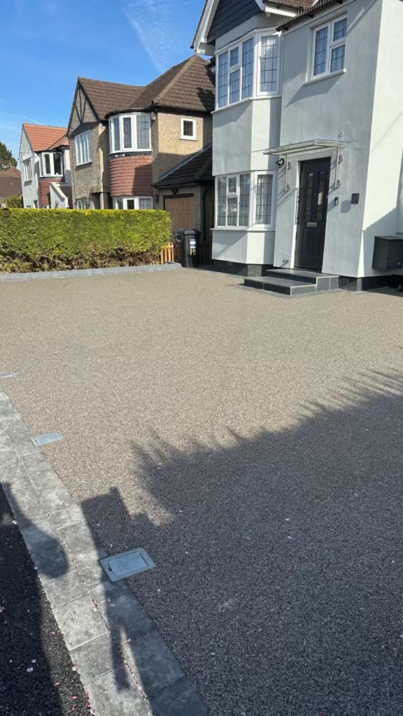Driveway with integrated utility covers, step detail and coordinated grey decorative surfacing