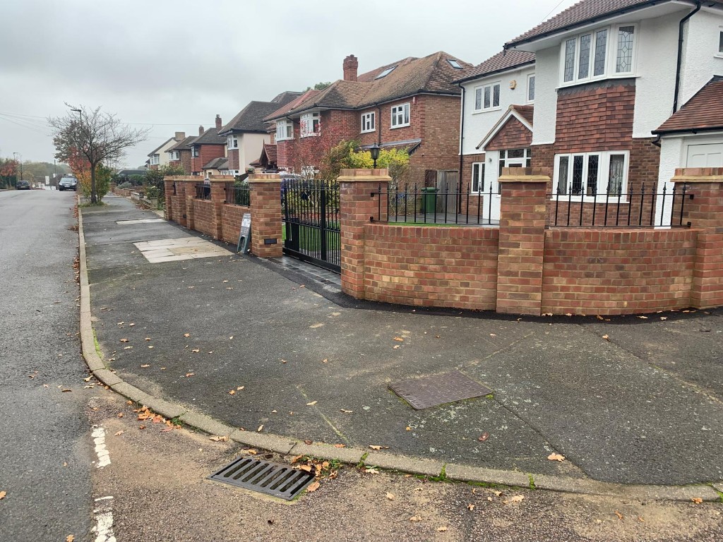 New red brick front boundary wall with black metal railings and double driveway gates