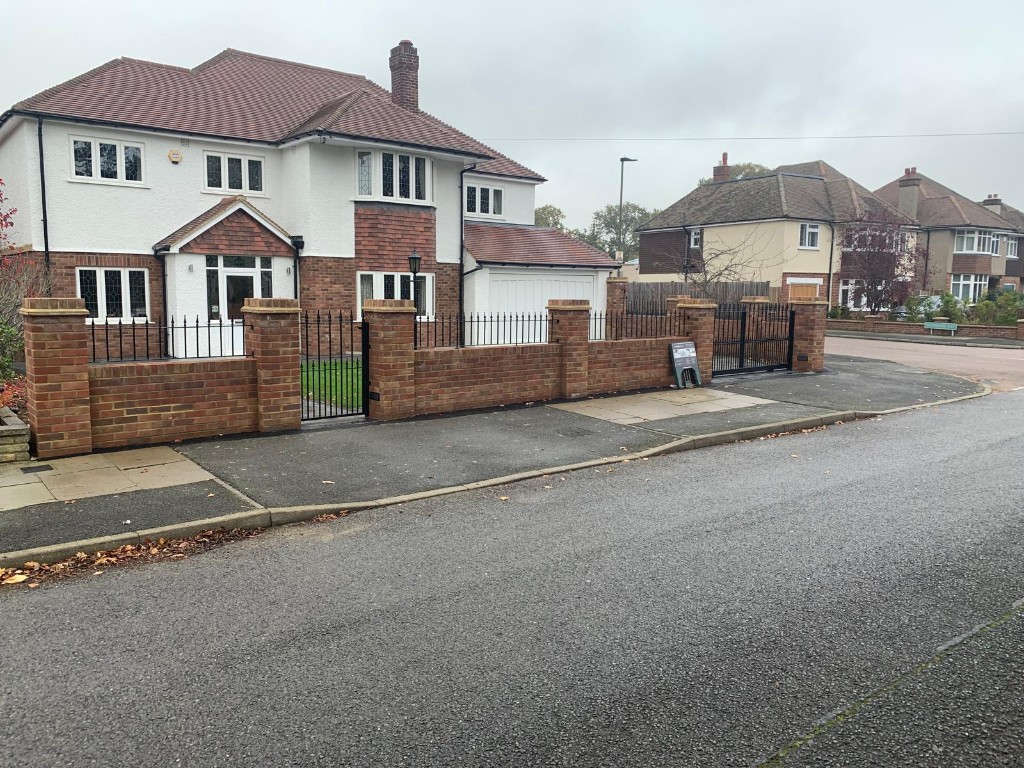 Detached house with new brick and metal boundary wall, lawn and driveway gates
